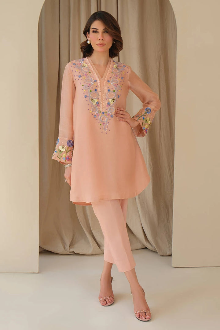 A confident portrait in Whimsical June from June Bloom ’25 by Nainpreet: blush embroidered 2-piece with pants listed on Nainpreet.