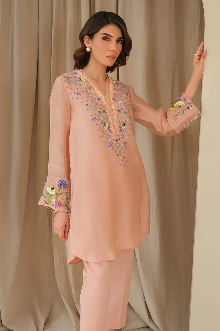 A distant portrait of Whimsical June from June Bloom ’25 by Nainpreet: blush embroidered 2-piece with pastel florals listed on Nainpreet 
