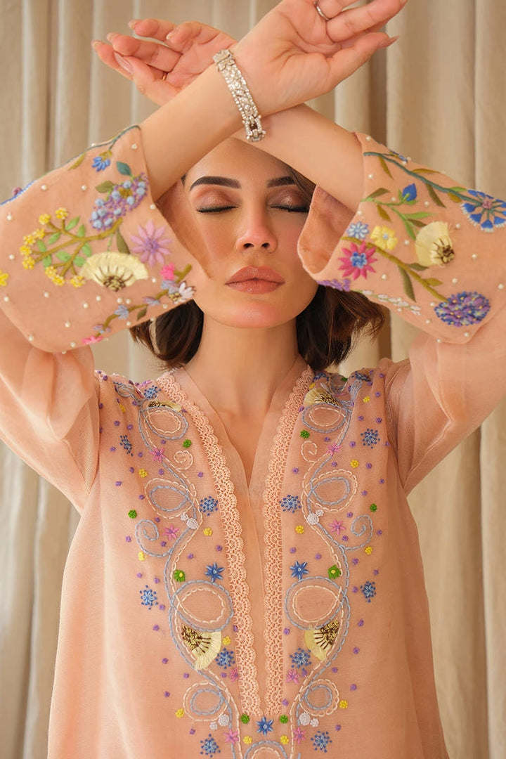 Close up of Whimsical June from June Bloom ’25 by Nainpreet: a blush embroidered shirt with pastel florals listed on Nainpreet
