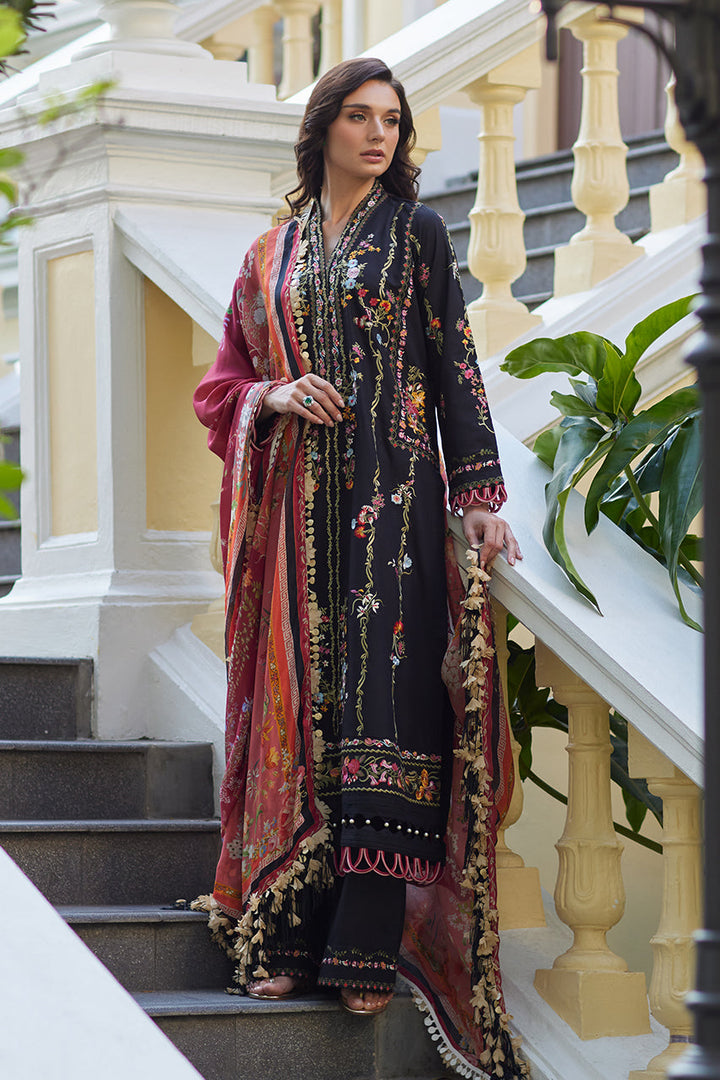 Girl in Enchanted Noir: a black lawn shirt & pants adorned with vibrant floral embroidery. This Luxury Lawn '25 ensemble includes a printed silk dupatta.