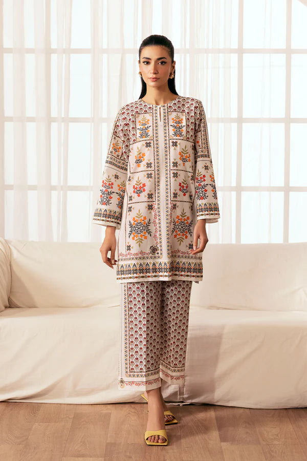 Cream-toned cambric set with multicolor embroidery and patterned trousers styled with yellow sandals, Pomegranate Blossom, Nainpreet.