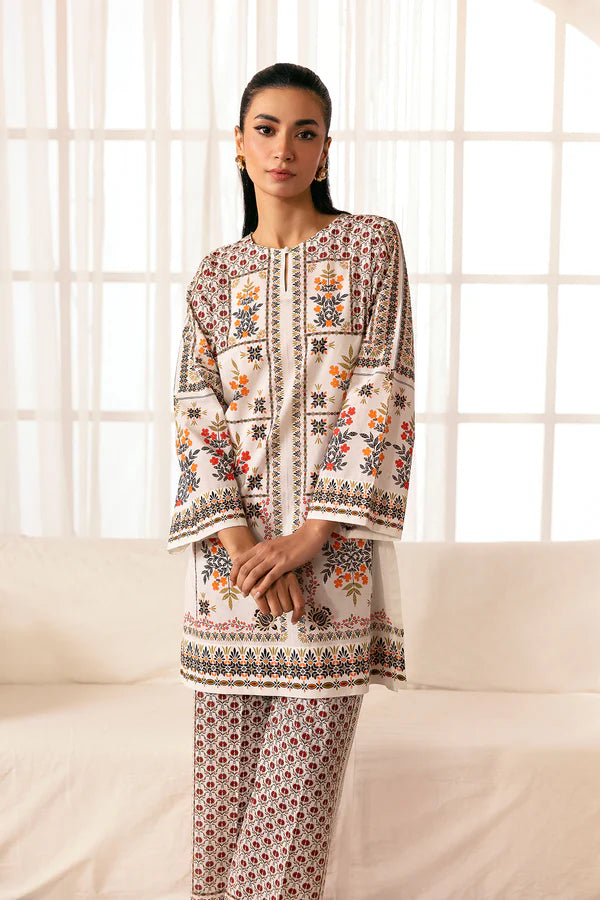 Printed cambric shirt in vibrant summer tones paired with floral motif trousers, Pomegranate Blossom, Nainpreet.
