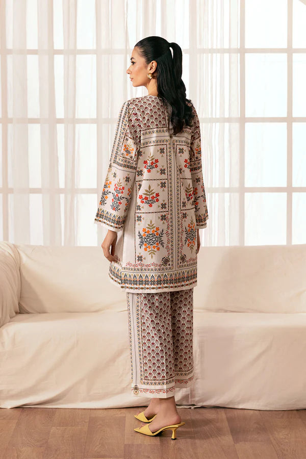 Back view of Pomegranate Blossom featuring printed cambric trousers with red floral motifs and bordered cuffs, Nainpreet
