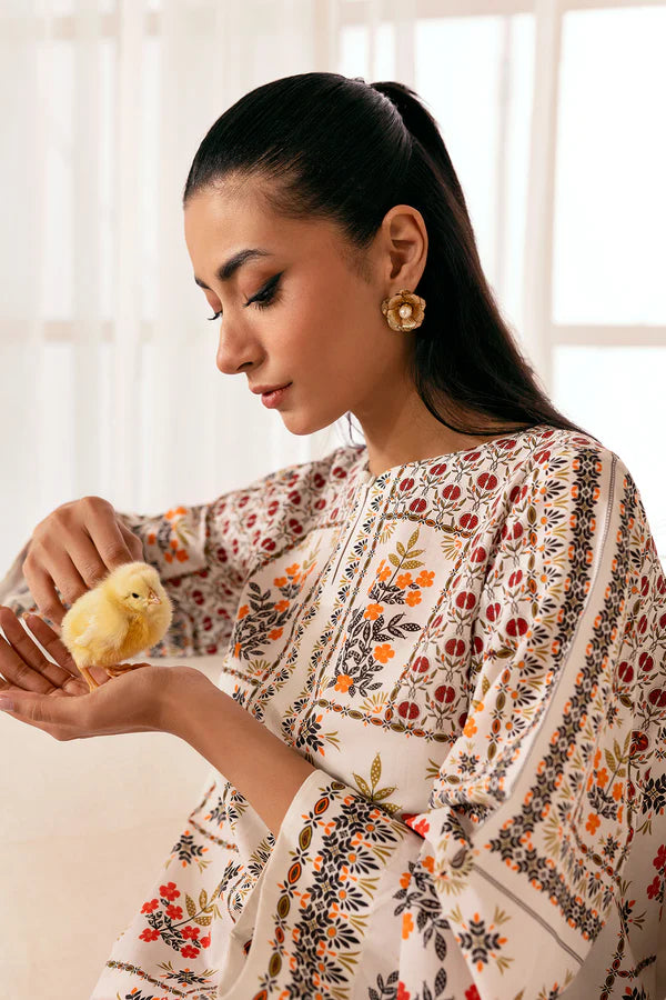 Holding a yellow chick with care, printed cambric shirt in warm multicolor tones, Pomegranate Blossom, Nainpreet.
