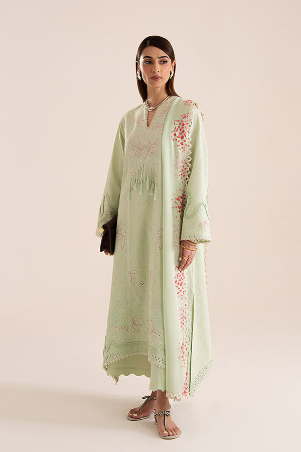Model wears Nore: a mint green jacquard lawn set with coral embroidery, scalloped culottes, and a printed chiffon dupatta.