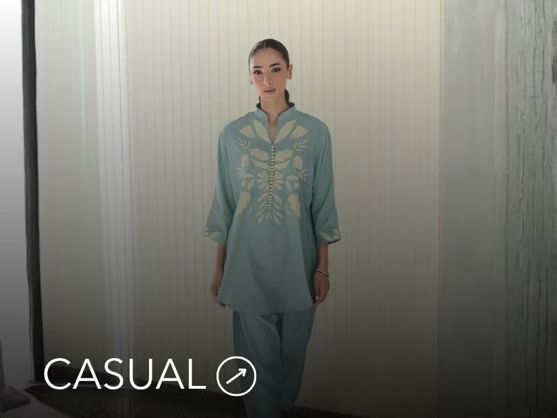 Model in a light blue casual kurta with floral and geometric prints; “Casuals” text below on Nainpreet’s banner..