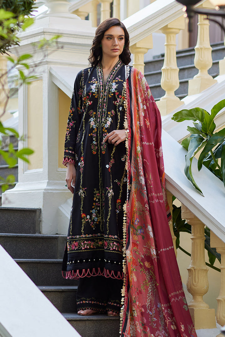 A model showcases Nainpreet Enchanted Noir: a luxury black lawn suit with floral embroidery with its printed silk dupatta, ideal for Indian festivities.