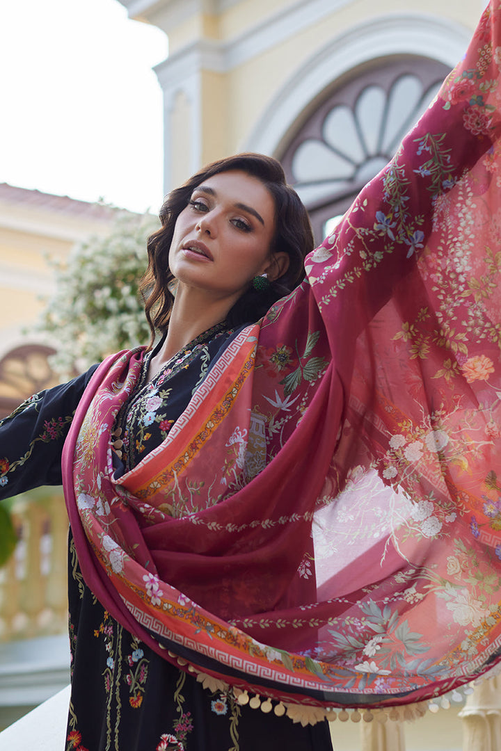 Nainpreet Enchanted Noir, a black lawn shirt with floral embroidery. Model showcases the beautiful dress with flowing printed silk dupatta. A vibrant Luxury Lawn '25 piece for Indian ceremonies.