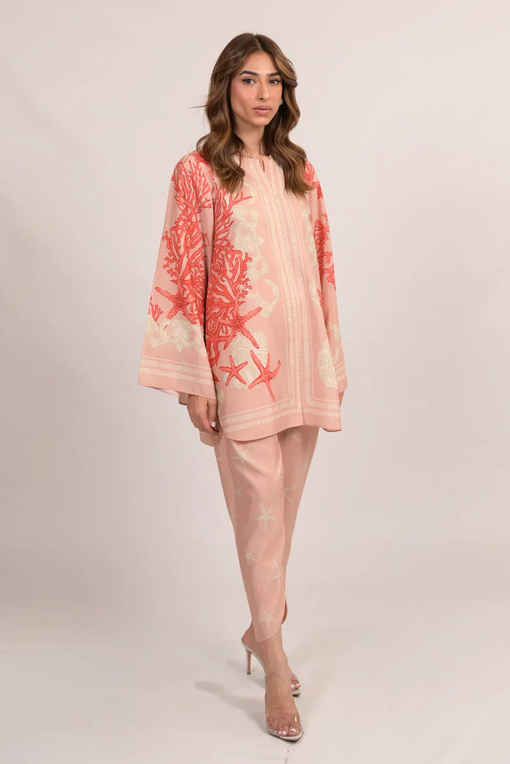 Marjan A styled in soft pink—cotton-silk co-ord with coral and starfish motifs, relaxed shirt and matching pants worn with clear heels.