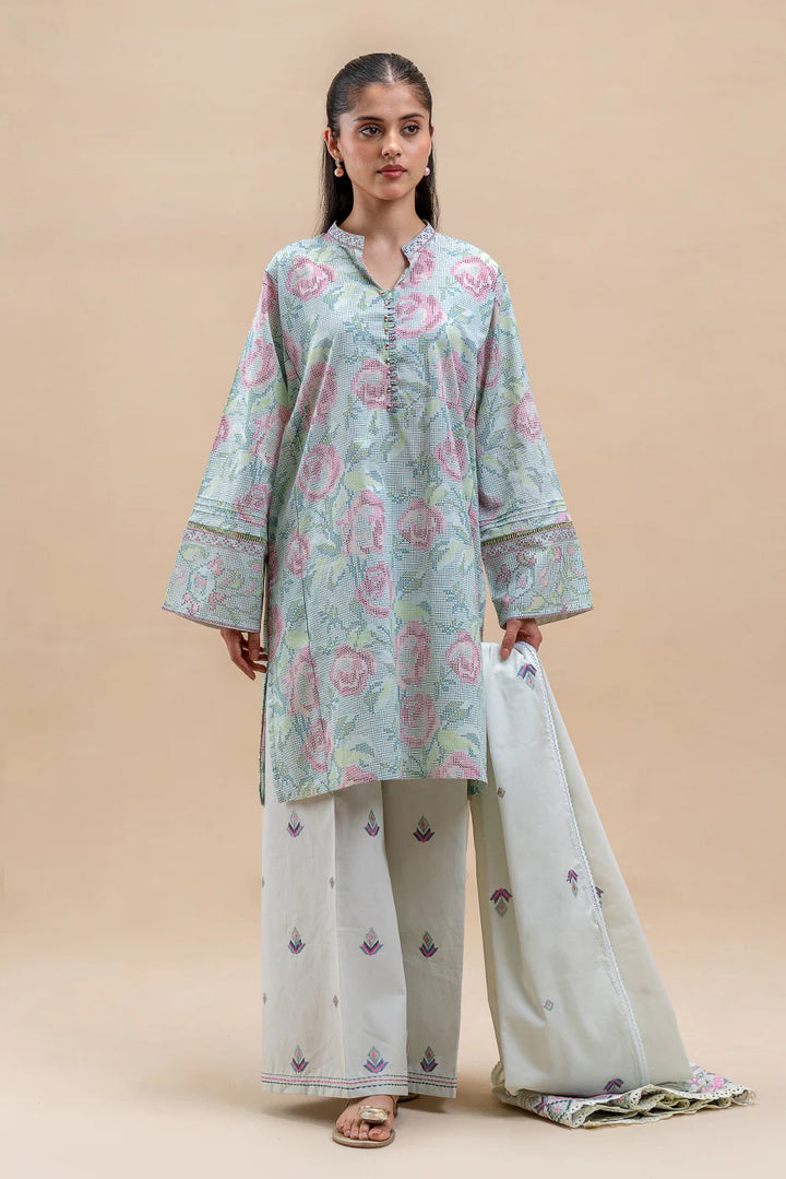 Close-up of printed lawn in Pastel Blush—gridwork florals in pink, green, and blue with band collar, decorative buttons, and soft summer texture.