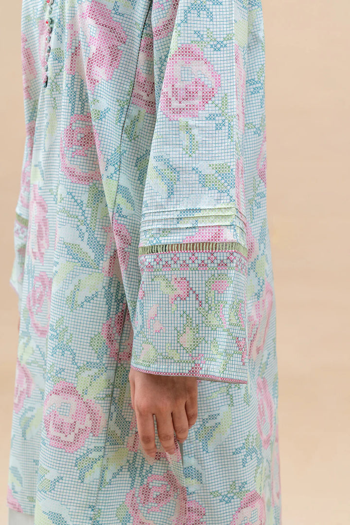 Wearing Pastel Blush—floral lawn kurta with embroidered neckline, palazzo trousers, and voil dupatta edged in soft threadwork.