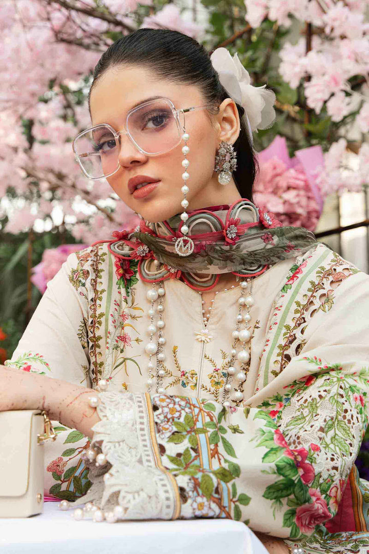 Portrait of the model in MPT-2605-A — embroidered florals in cream and pink, pearl jewellery and monogram scarf framed by cherry blossoms.
