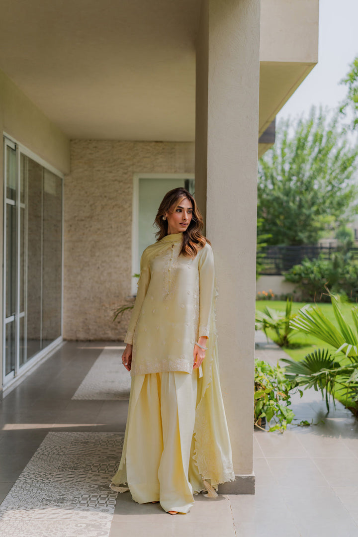 Butter-lime raw silk set with delicate white embroidery, styled in a garden-facing corridor with farshi grace — Lime Zest, Eid Ul Adha ’25 via Nainpreet.