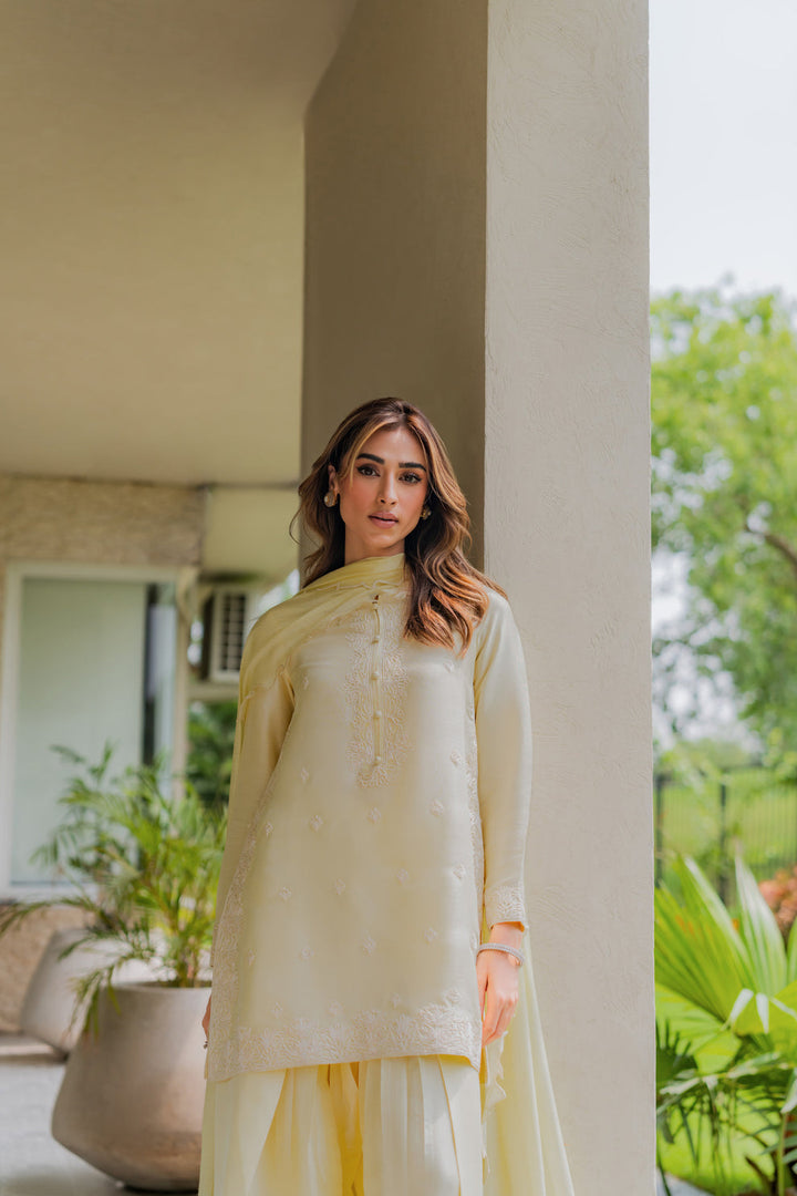 A beautiful portrait in Lime Zest — butter-lime raw silk softened by garden light, embroidery catching the breeze beside potted greens. Eid Ul Adha ’25 via Nainpreet.